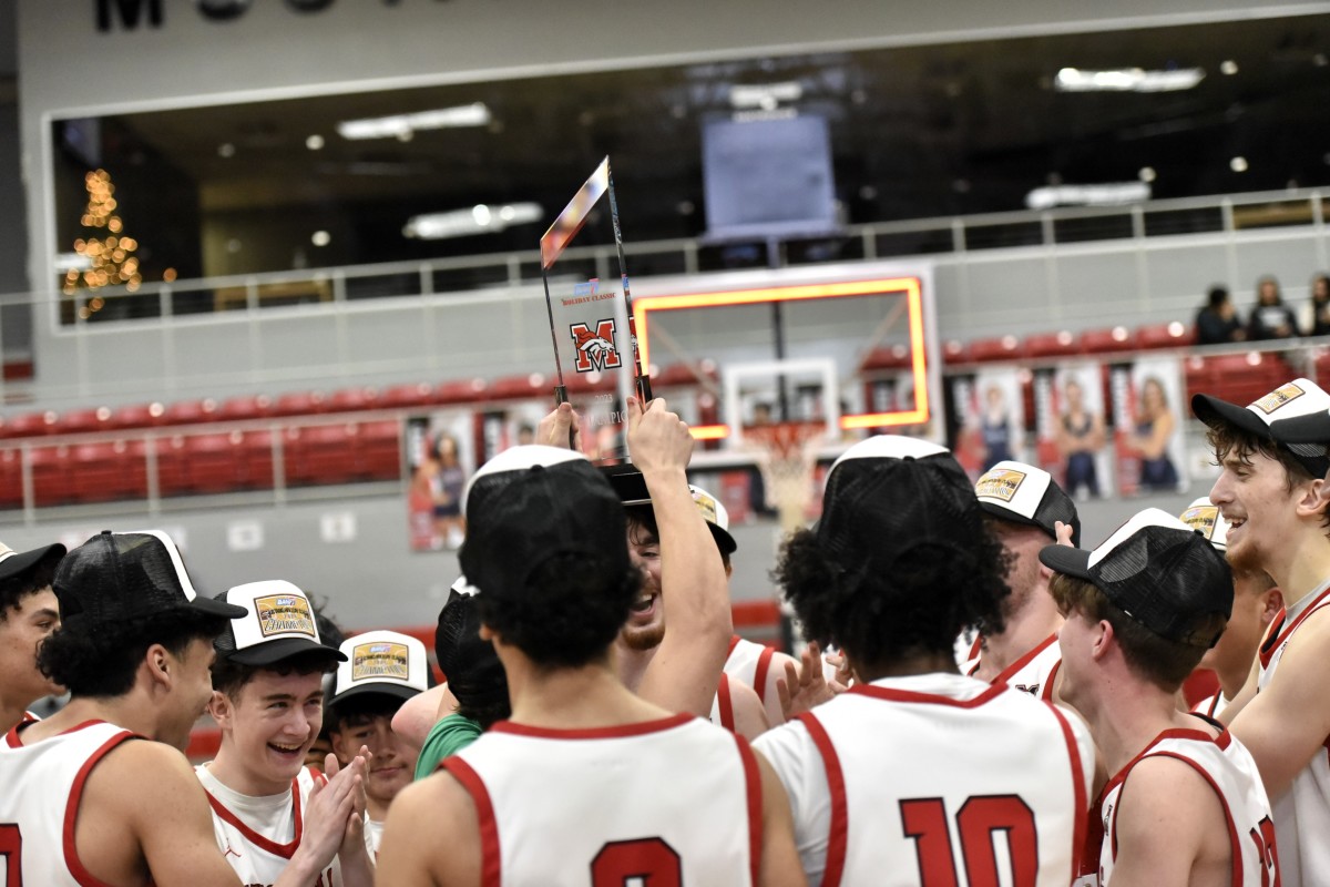 Mustang players celebrate after the Broncos claimed the boys championship of their Mustang Holiday Classic on Dec. 30, 2023.